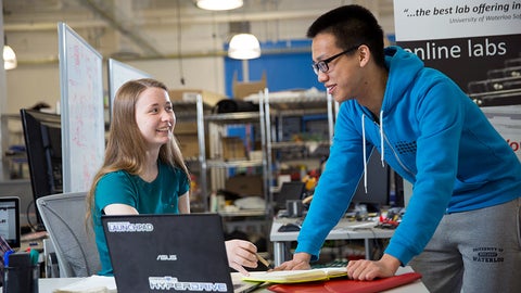 Two students smiling and chatting