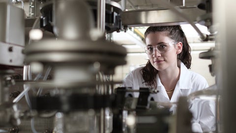 Student looking at a machine