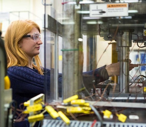 Student working on a machine in a lab