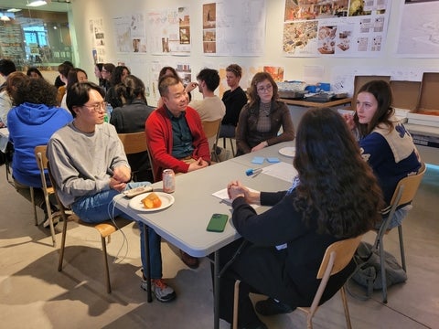 students talking around a table