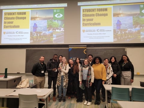 group of people standing at the front of lecture hall