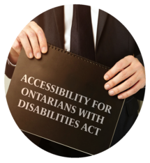 Person holding notebook that says &quot;Accessibility for Ontarians with Disabilities Act&quot;