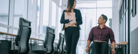 Accessible photo of man in a wheelchair talking with a colleague