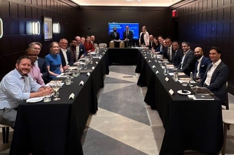 Alumni sit together at a New York City event