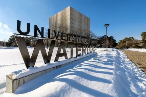 University of Waterloo sign sits in front of Dana Porter Library in the winter