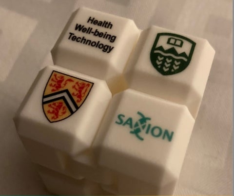 Infinity cube depicting collaboration between universities