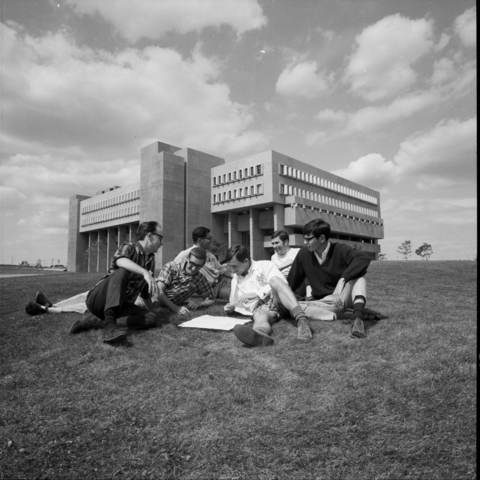 1968 a group of students siting outside of MC