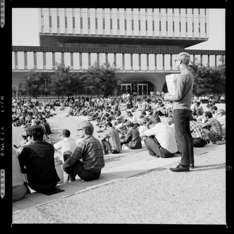 A group of people sitting outside Dana Porter Library