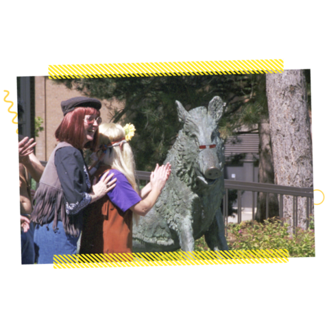 People clapping near a boar statue in 1998