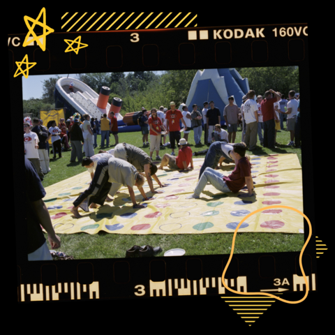 Group of students on film playing twister with yellow graphics around
