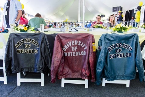 University of Waterloo leather jackets draped across three chairs