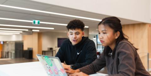 students looking at a laptop