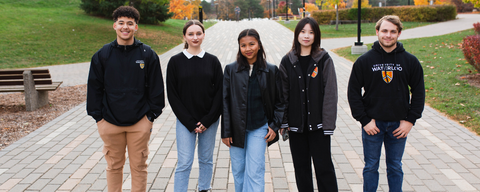 five university of waterloo students standing and smiling at the camera