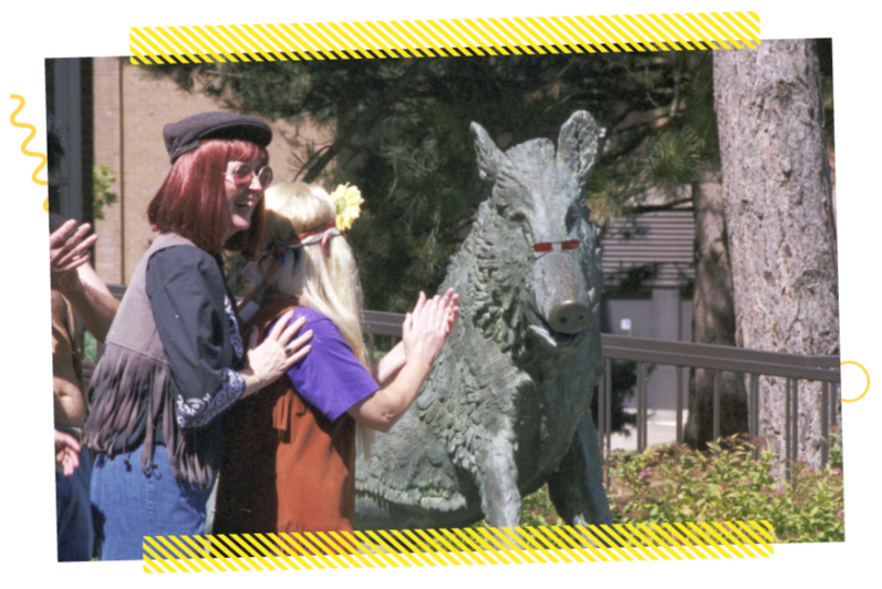 People clapping near a boar statue in 1998