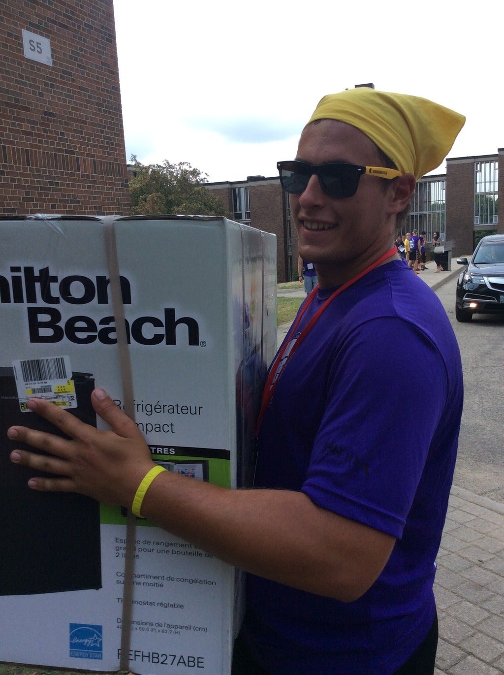 Young man moving a box.