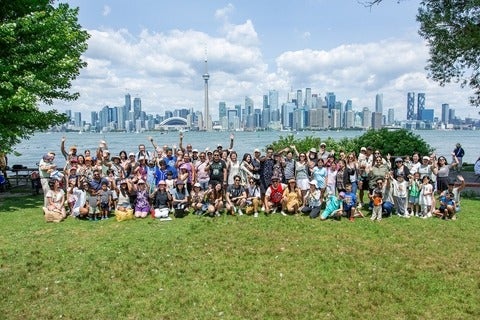 Alumni Family Day attendees posing for a group photo set in front of the Toronto skyline