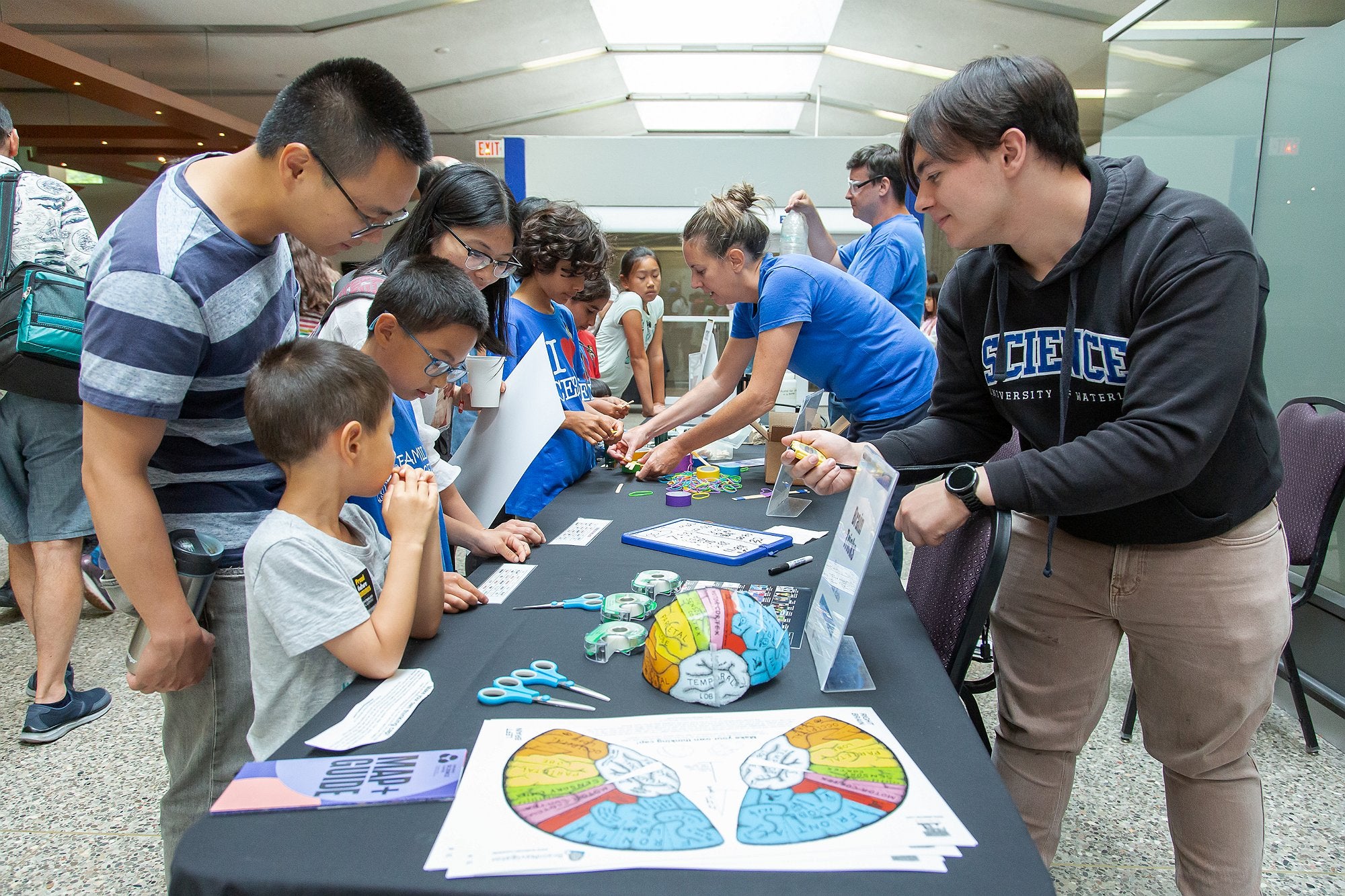 Volunteers teaching children how to make brain maps