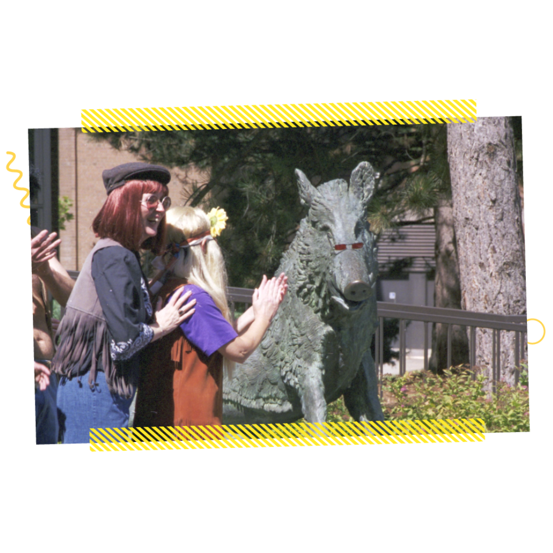 People clapping near a boar statue in 1998