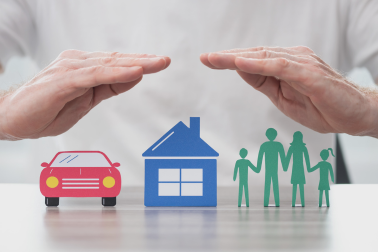 photo of a hand abouve a car, home and family indicating car insurance, home insurance and life insurance