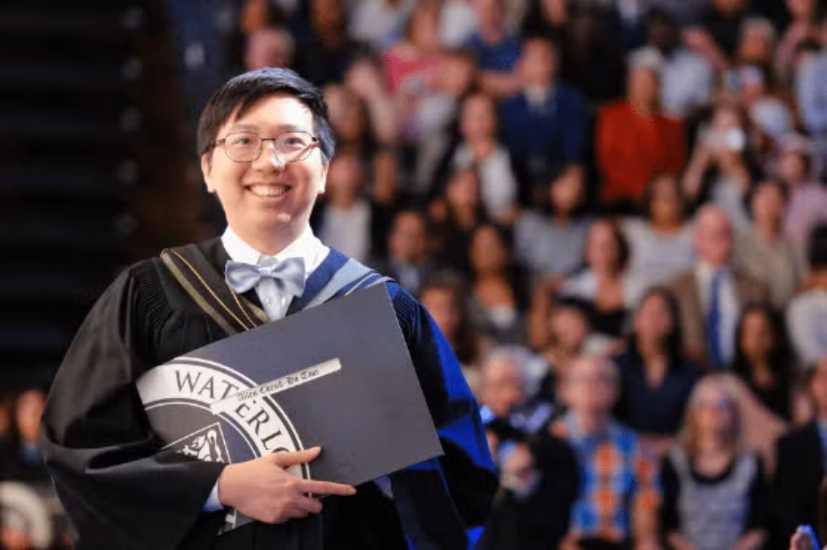 Boy holding diploma at Convocation