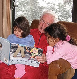 David Johnston reading to his grandchildren Tea and Emma