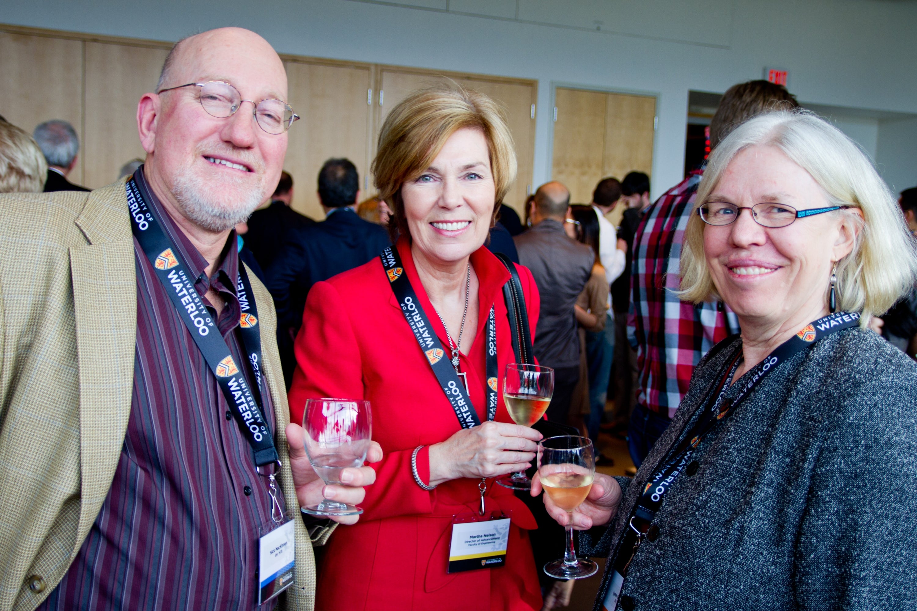 Three alumni posing at a networking event