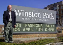 Photo of Ronald Schlegel in front of Winston Park sign