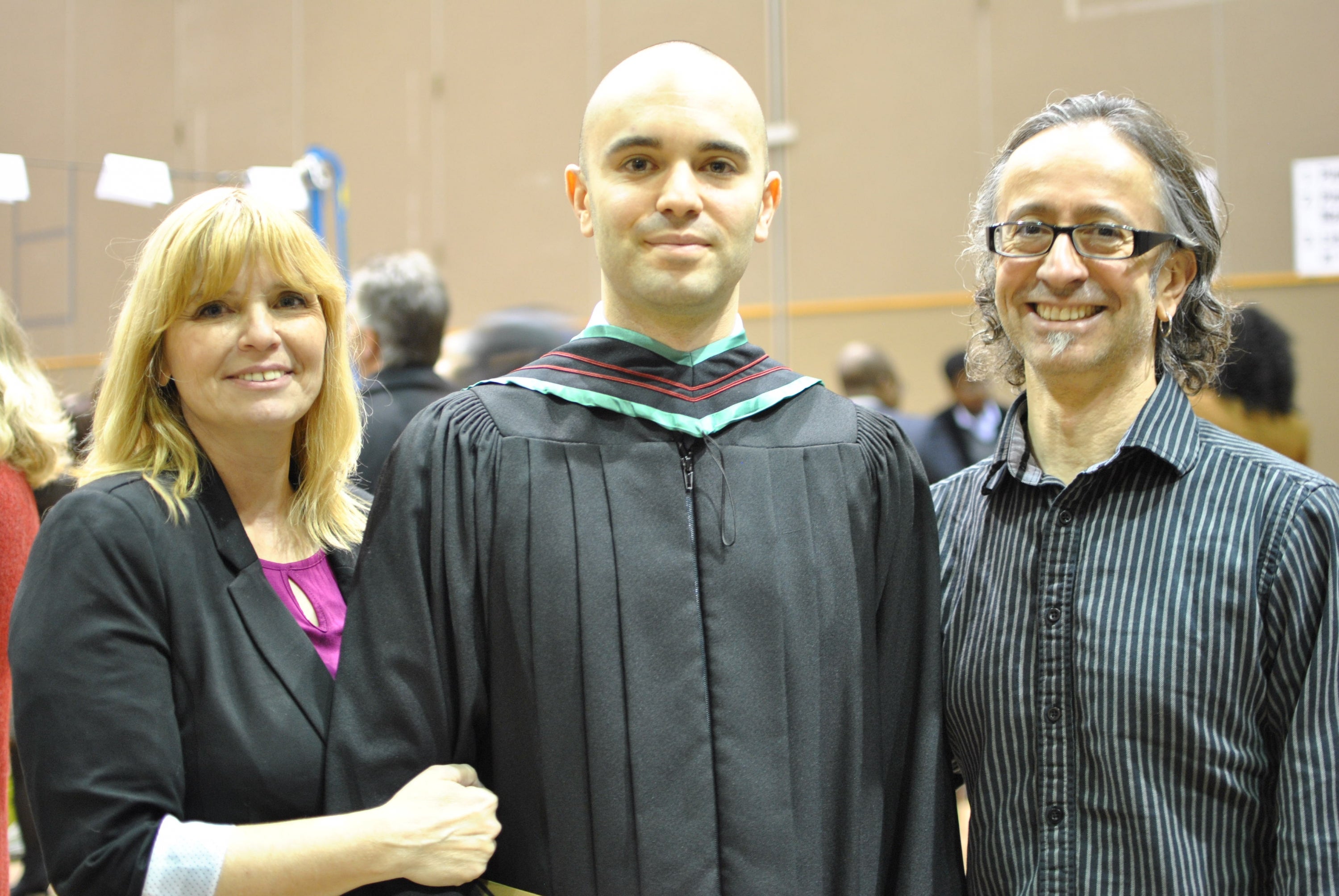 with his mom and dad at convocation