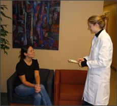 A researcher speaking to a patient 