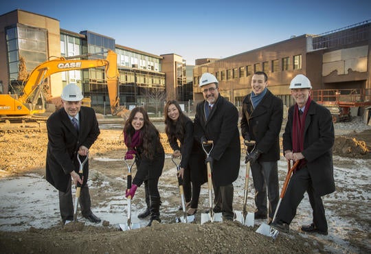 Dean James Rush, student and University administration put shovels in ground for official building groundbreaking.