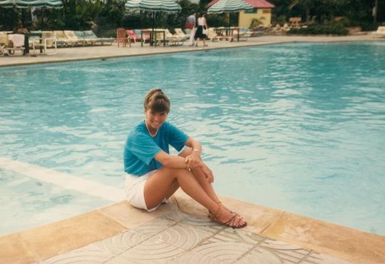 Andrea Fraser sitting on pool deck.