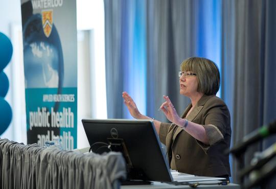 The Honourable Anne McLellan delivers anniversary lecture at podium.