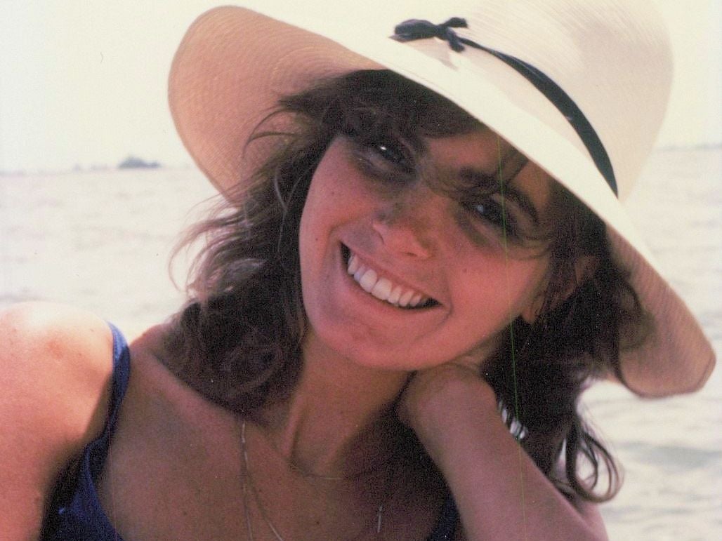 Andrea Fraser on beach smiling.