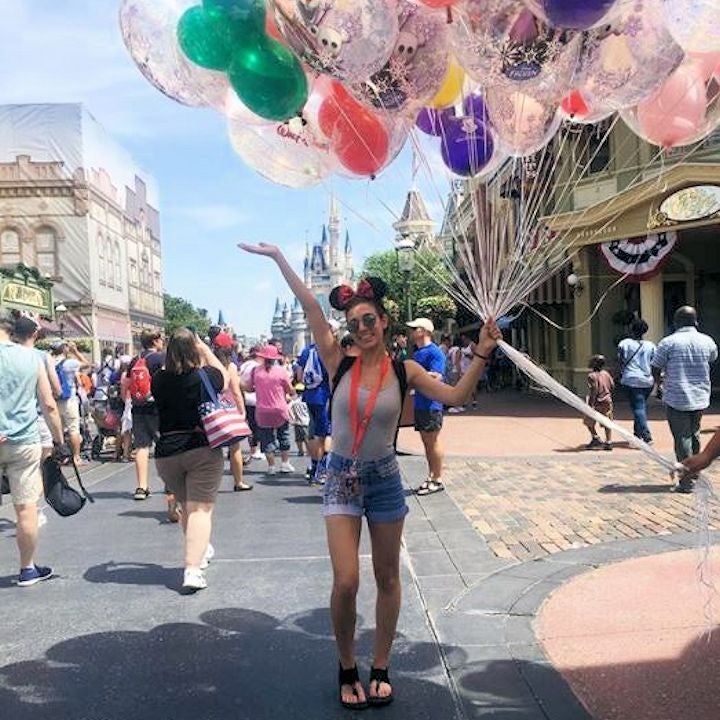 Chloe Lemieux holding balloons at Disney.