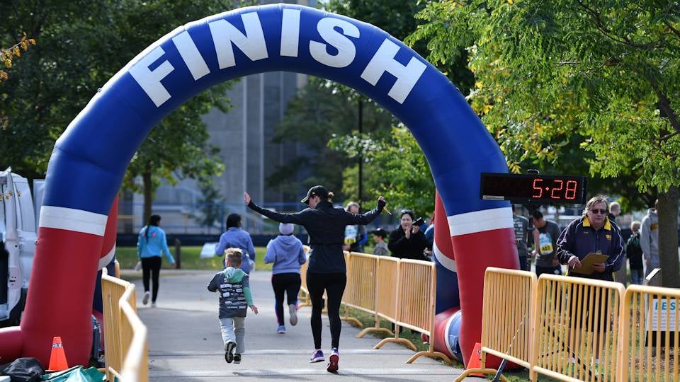 Mother and son high five at finish line.