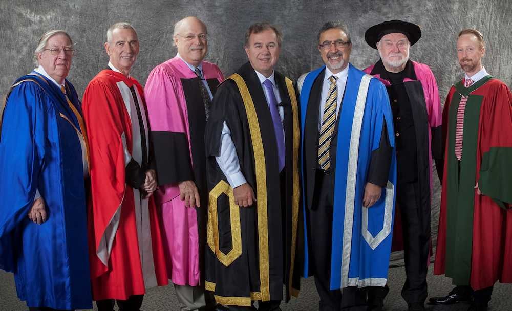 Mihaly Csikszentmihalyi and Brant Fries in convocation robes with university representatives.