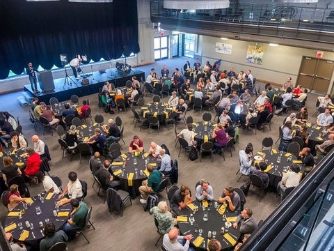 people at tables at a conference 