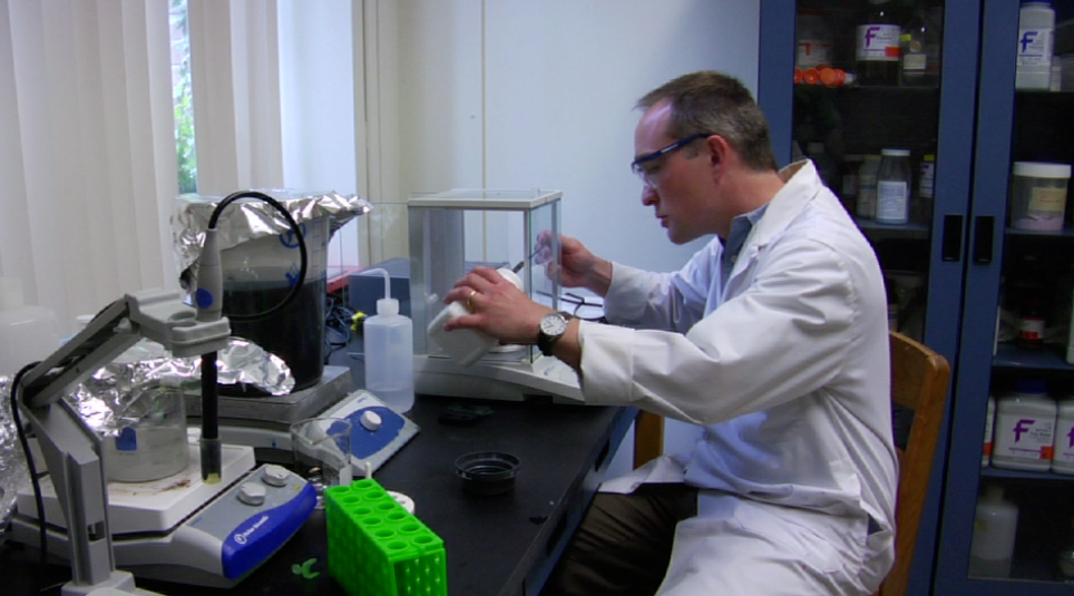 Professor working on a work bench