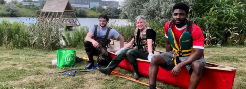 students sitting on canoe