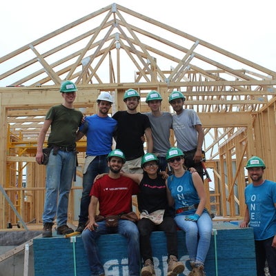 students in front of house frame