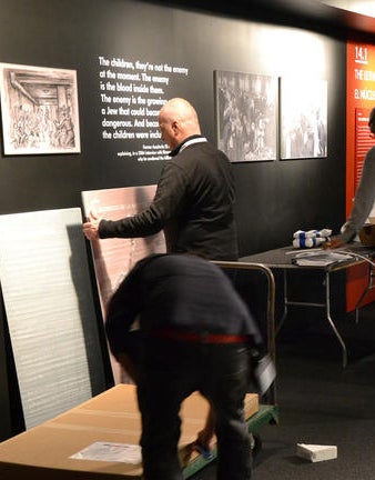 Jan van Pelt helps install the exhibit at the Museum of Jewish Heritage in New York City