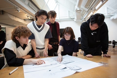students discussing an architectural drawing