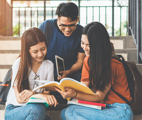 three students studying together