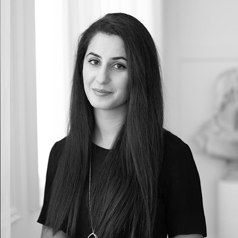 Black and white headshot of Masha Malek