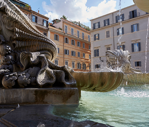 Fontana di Santa Maria in Trastevere Rome with the Rome campus building of the School of Architecture in the background