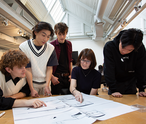 students discussing an architectural drawing