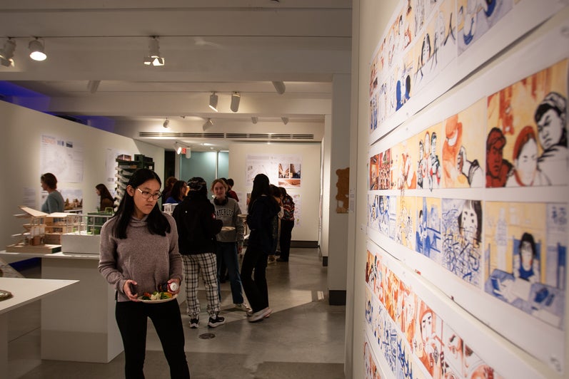 People looking at an installation of an architectural drawing in the projects review 2023 exhibition