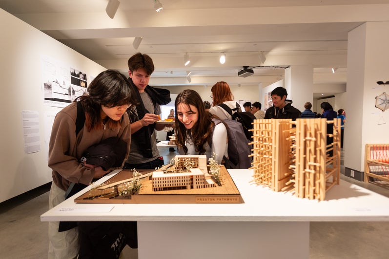 People looking at an installation of an architectural model in the projects review 2023 exhibition