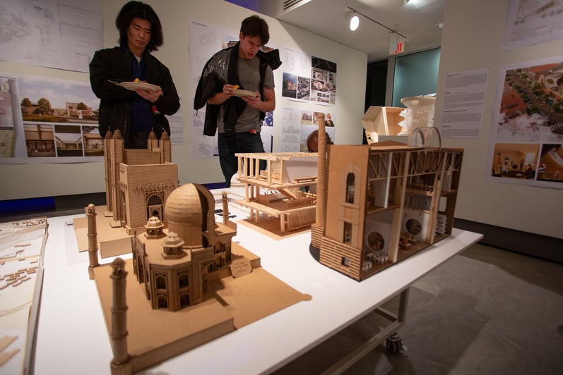 People looking at an installation of an architectural model in the projects review 2023 exhibition