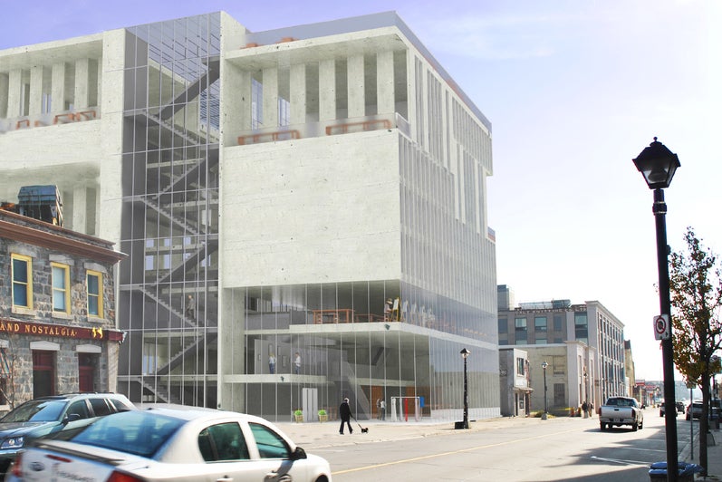 An exterior street view render of the building. The design is rather block-ish in form, completed with glass facades.